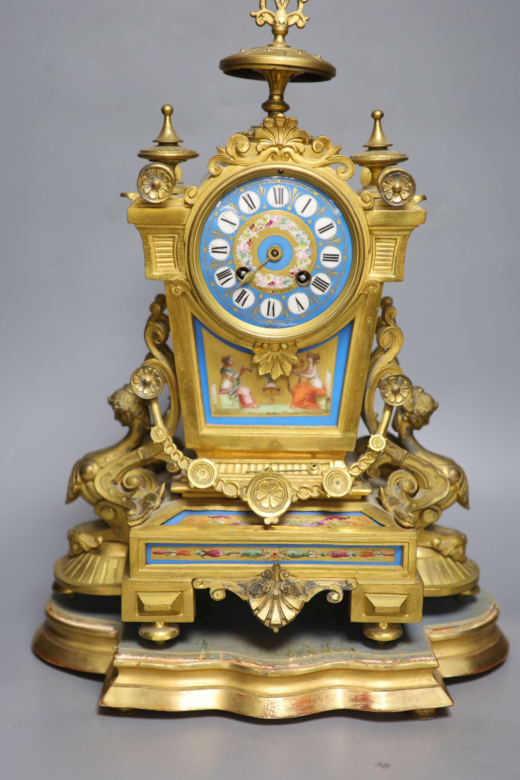 A French gilt metal and Sevres style porcelain mounted mantel clock, on plinth, with key and pendulum, overall height 49cm